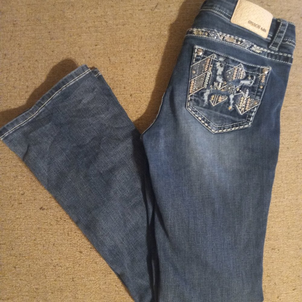 Grace in LA Jean's with pink and blue pocket embellishments